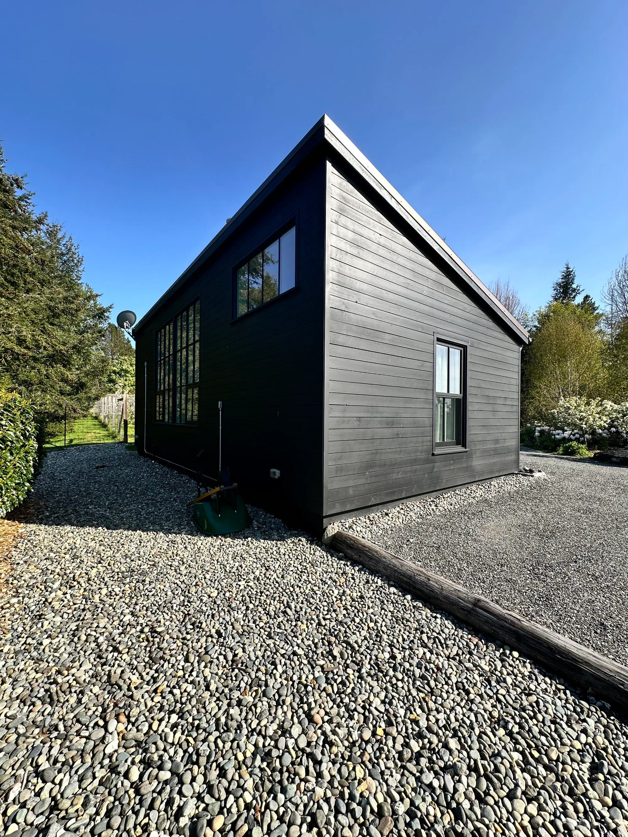 Modern dark-clad building exterior with angular roofline